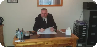 Mr William D Bruce (Billy) at his desk in the Funeral Home