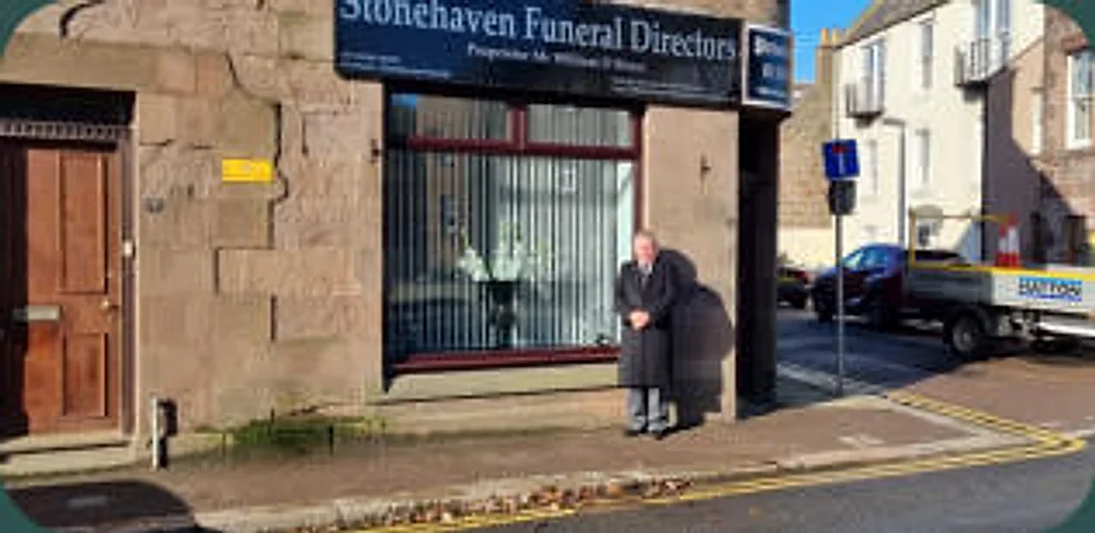 The Stonehaven Funeral Directors Funeral Home at 9 Bridgefield, with Mr William D Bruce standing outside